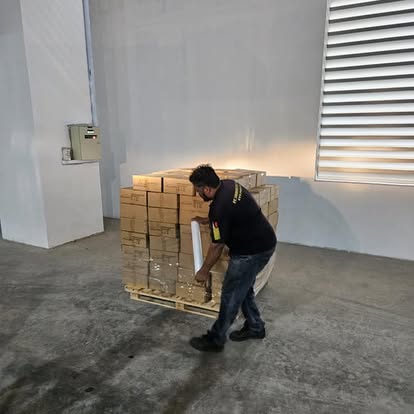 Worker preparing pallet for shipment